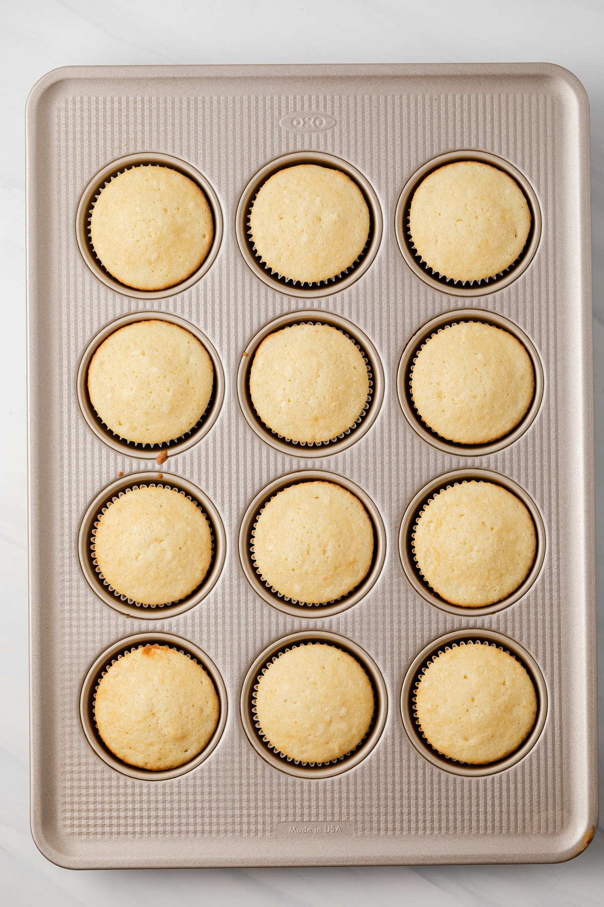 Almond cupcakes in muffin pan.