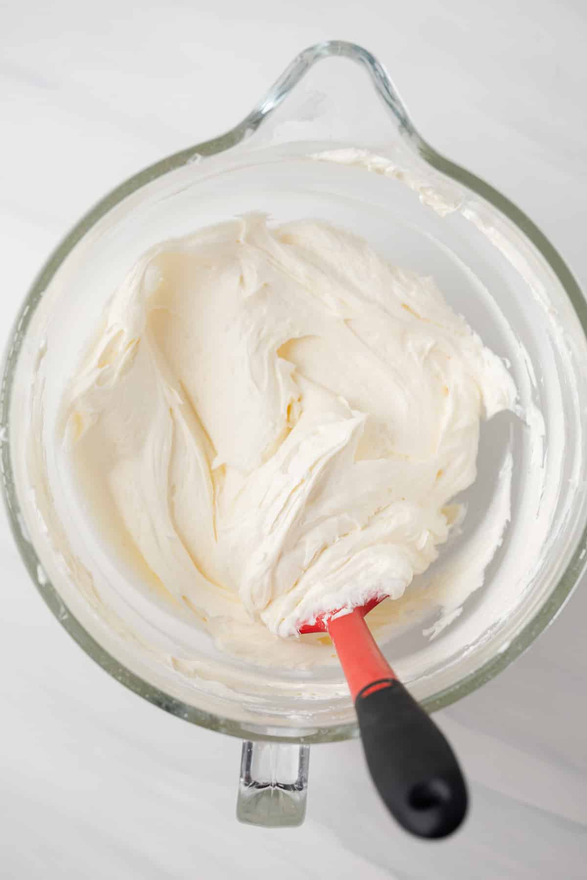 Almond frosting in glass bowl.