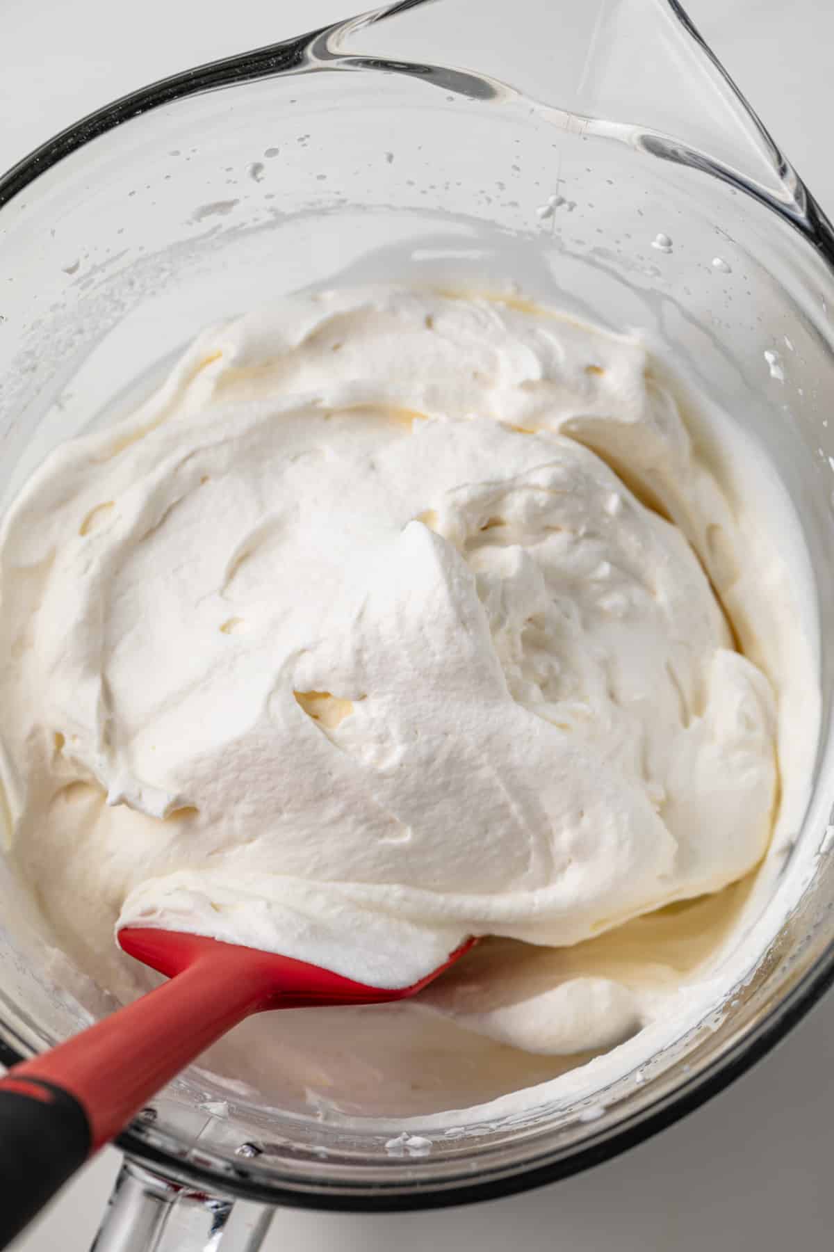 Whipped cream in a glass bowl.