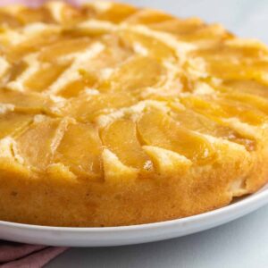 side view of apple cake on a white plate