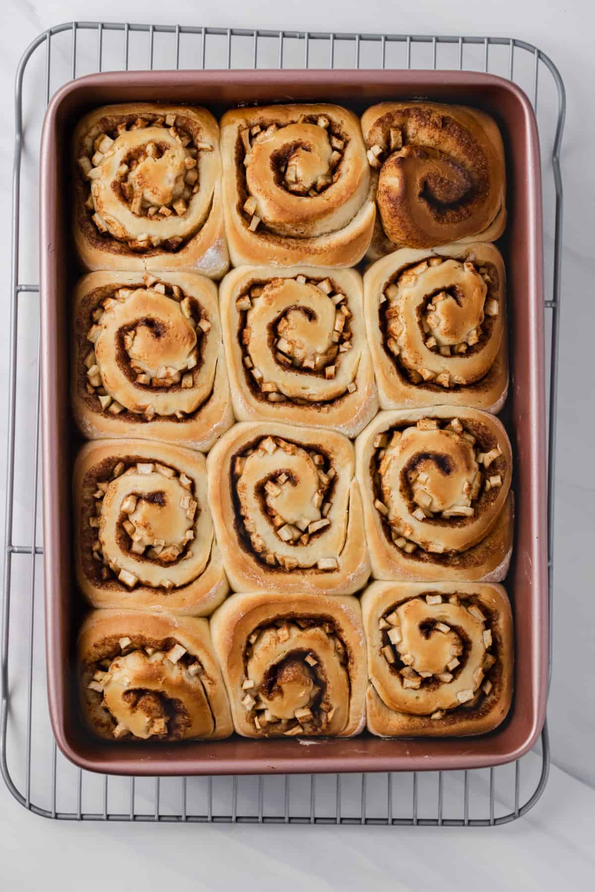 Freshly baked apple cinnamon buns in a baking dish