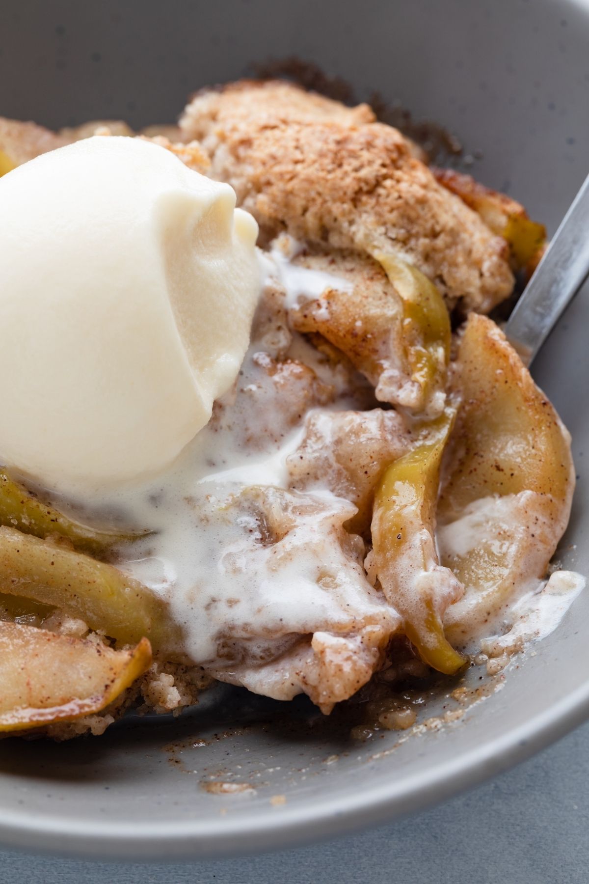close up overhead view of apple cobbler and ice cream in a bowl