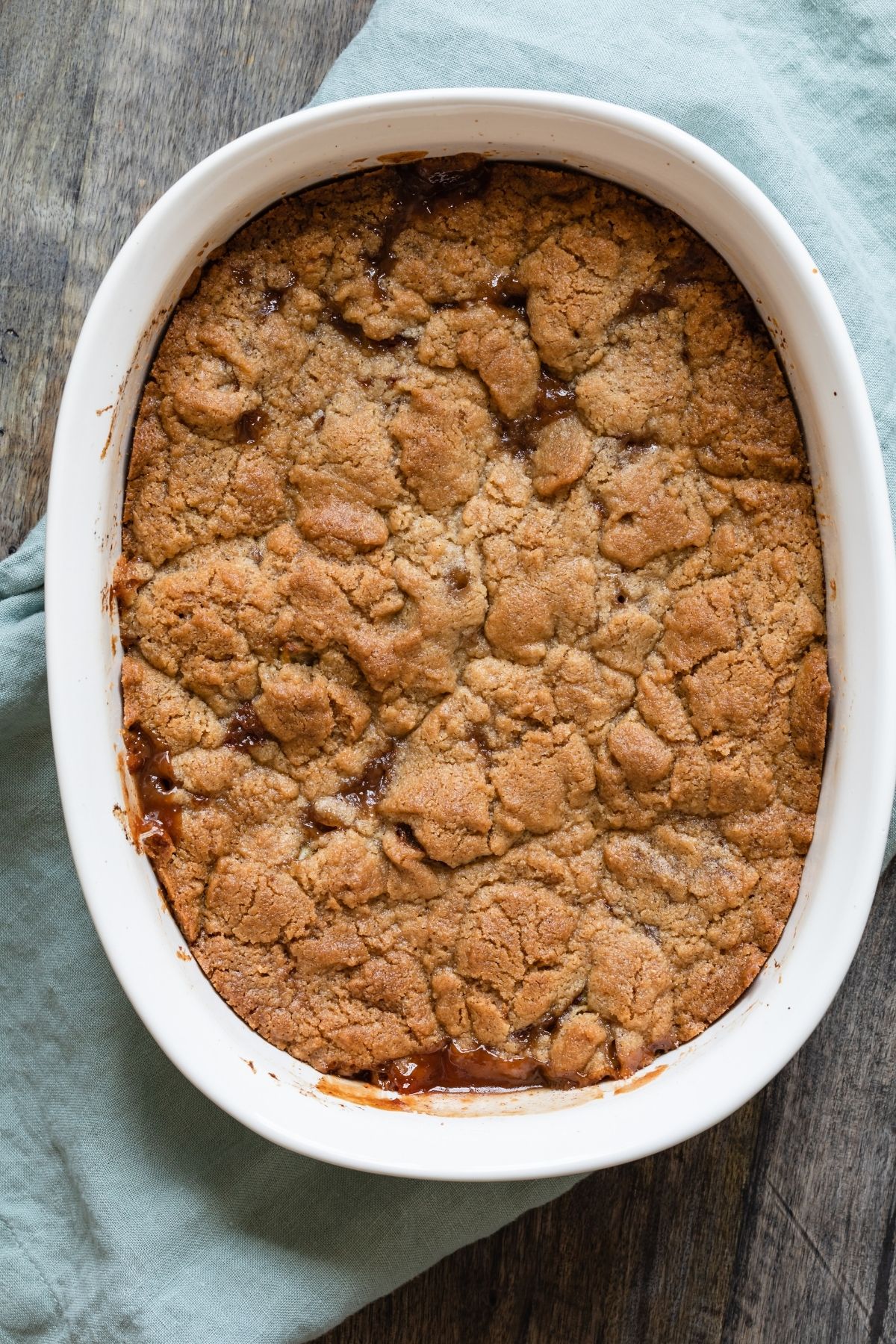 overhead of apple crumble in a white baking dish