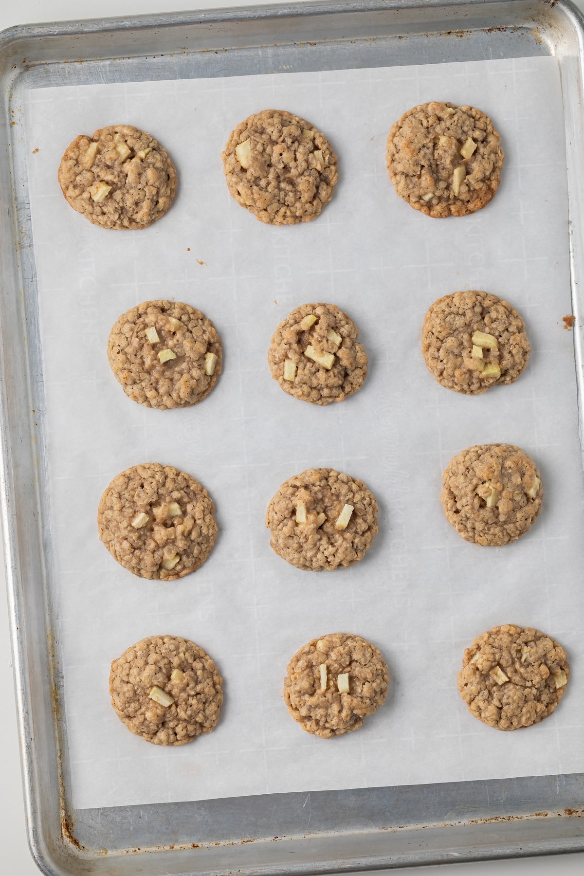 Apple oatmeal cookies on a baking sheet.