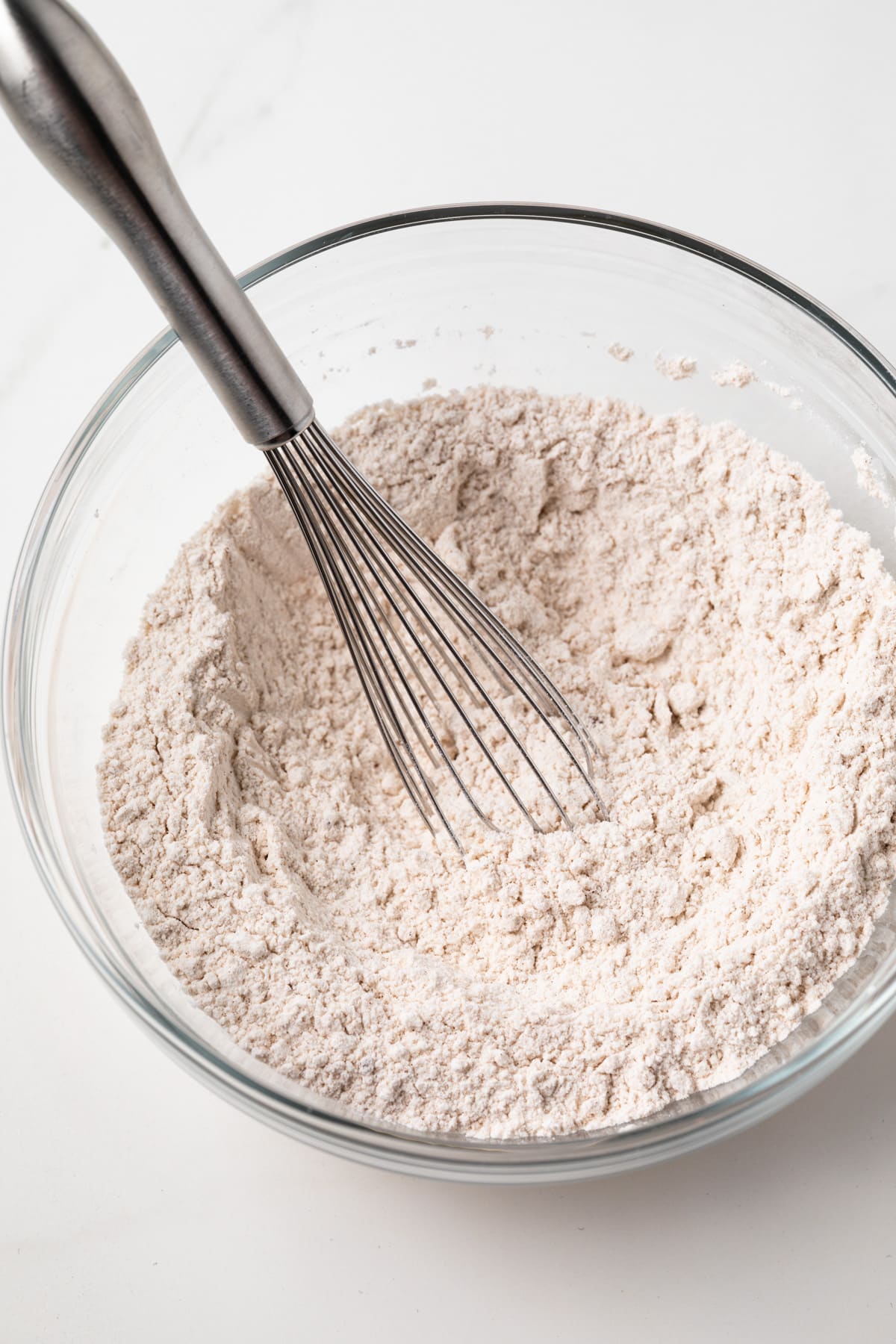 Dry ingredients mixed in glass bowl.