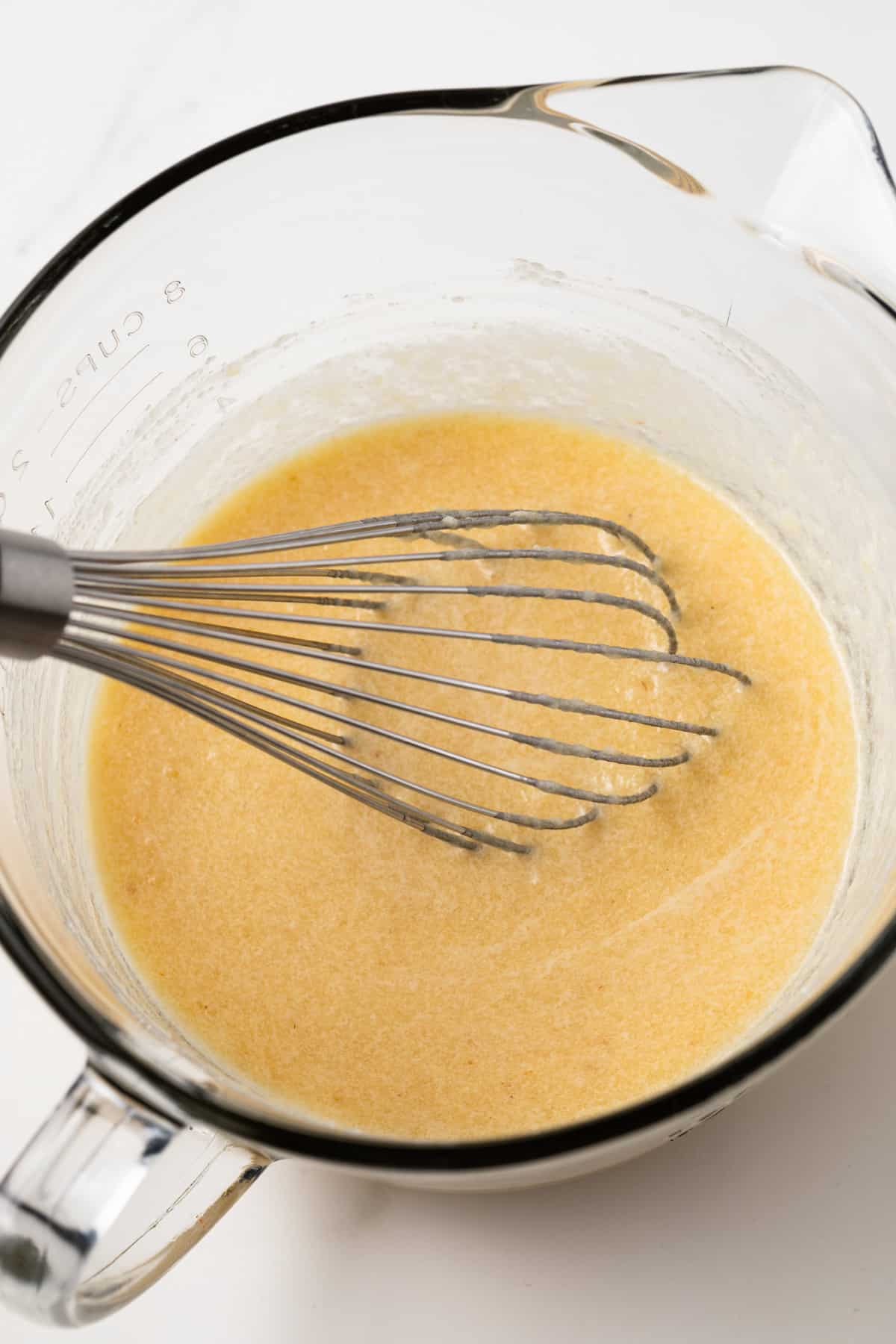 Wet ingredients mixed in glass bowl.