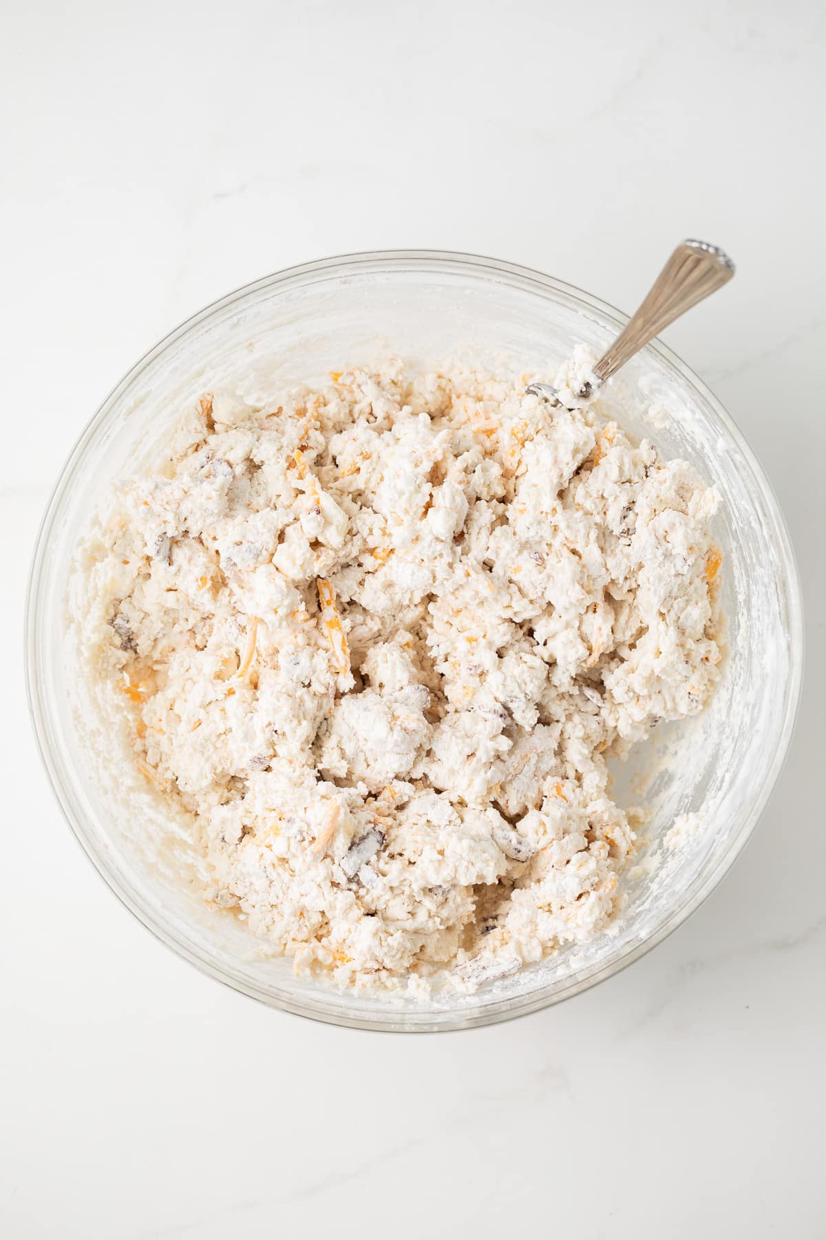 Biscuit dough in a glass bowl.