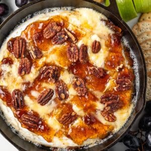 Baked brie with crackers, apples, and grapes.