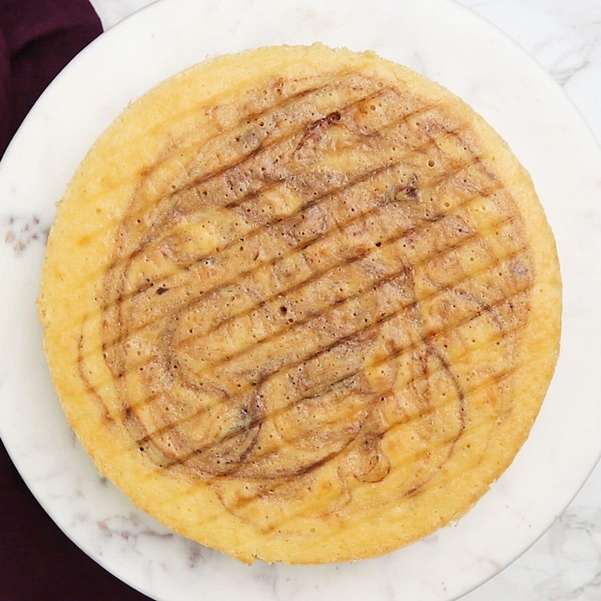 baked marble cake layer on cake stand