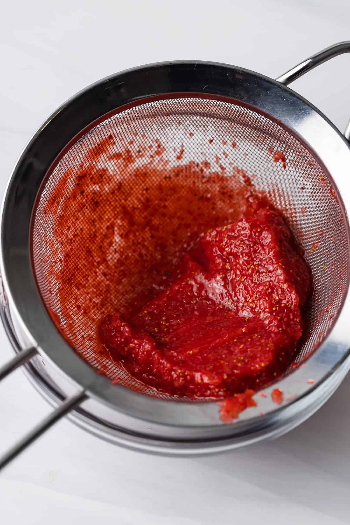 Strawberry pulp in the sieve