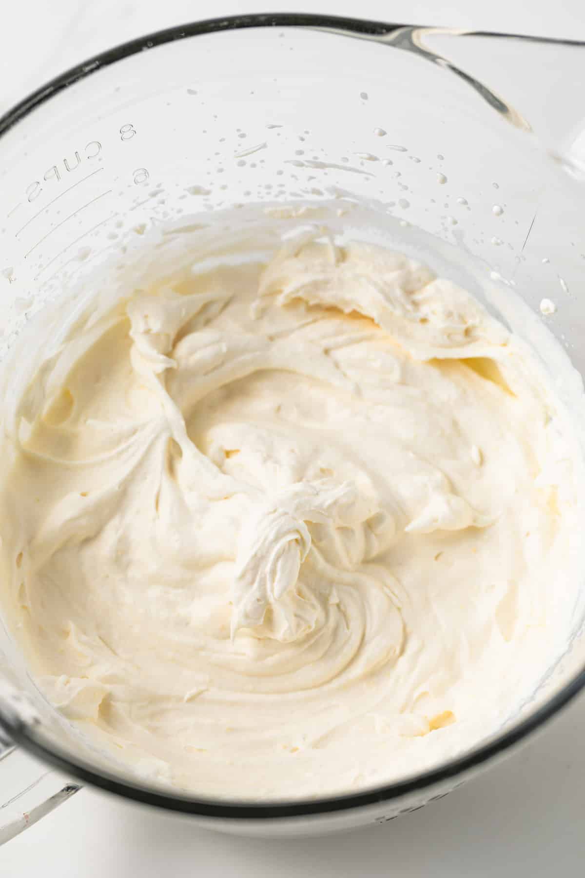 Whipped cream topping in a glass bowl.