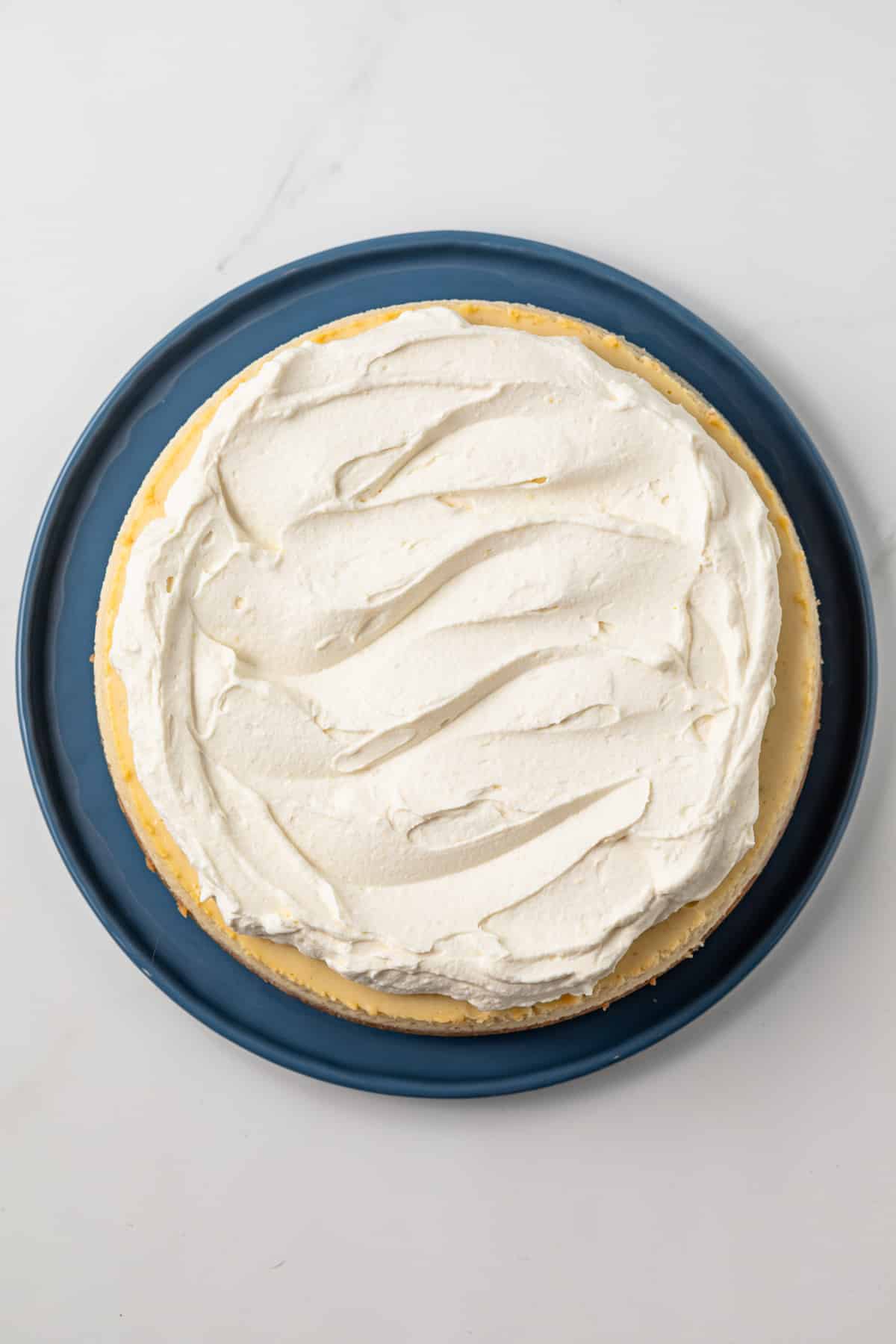 Banana cheesecake topped with whipped cream.