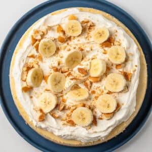 Banana pudding cheesecake on blue serving plate.