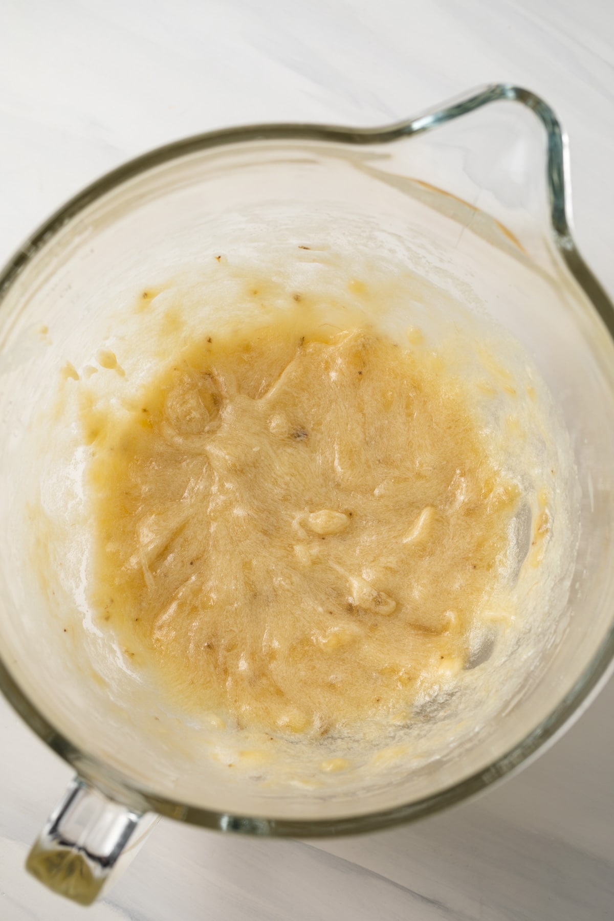 Mashed bananas in mixing bowl.