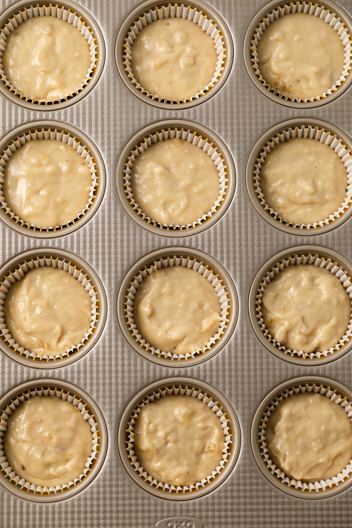 Banana cupcake batter in muffin pan.