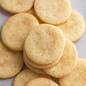 overhead view of basic butter cookies scattered on white parchment paper