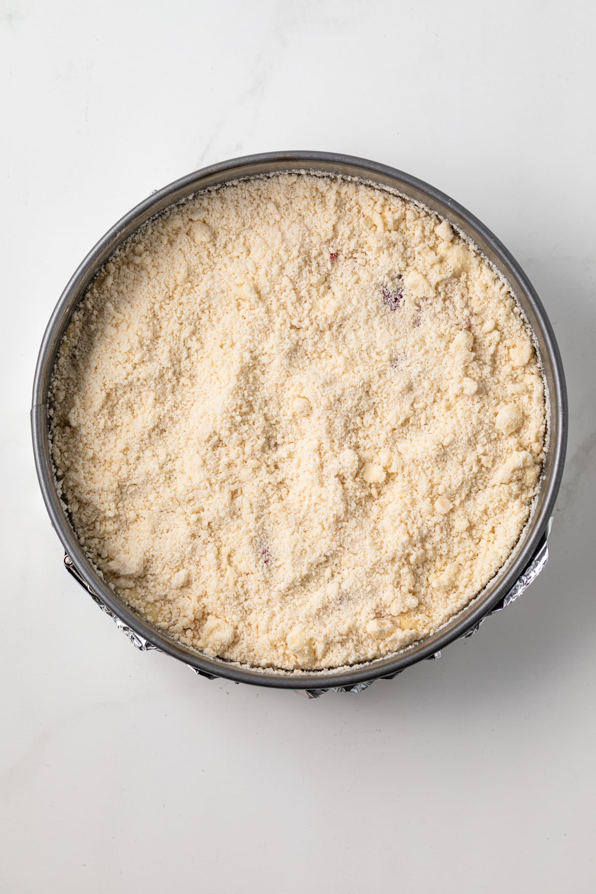 Crumb topping over berry cake.