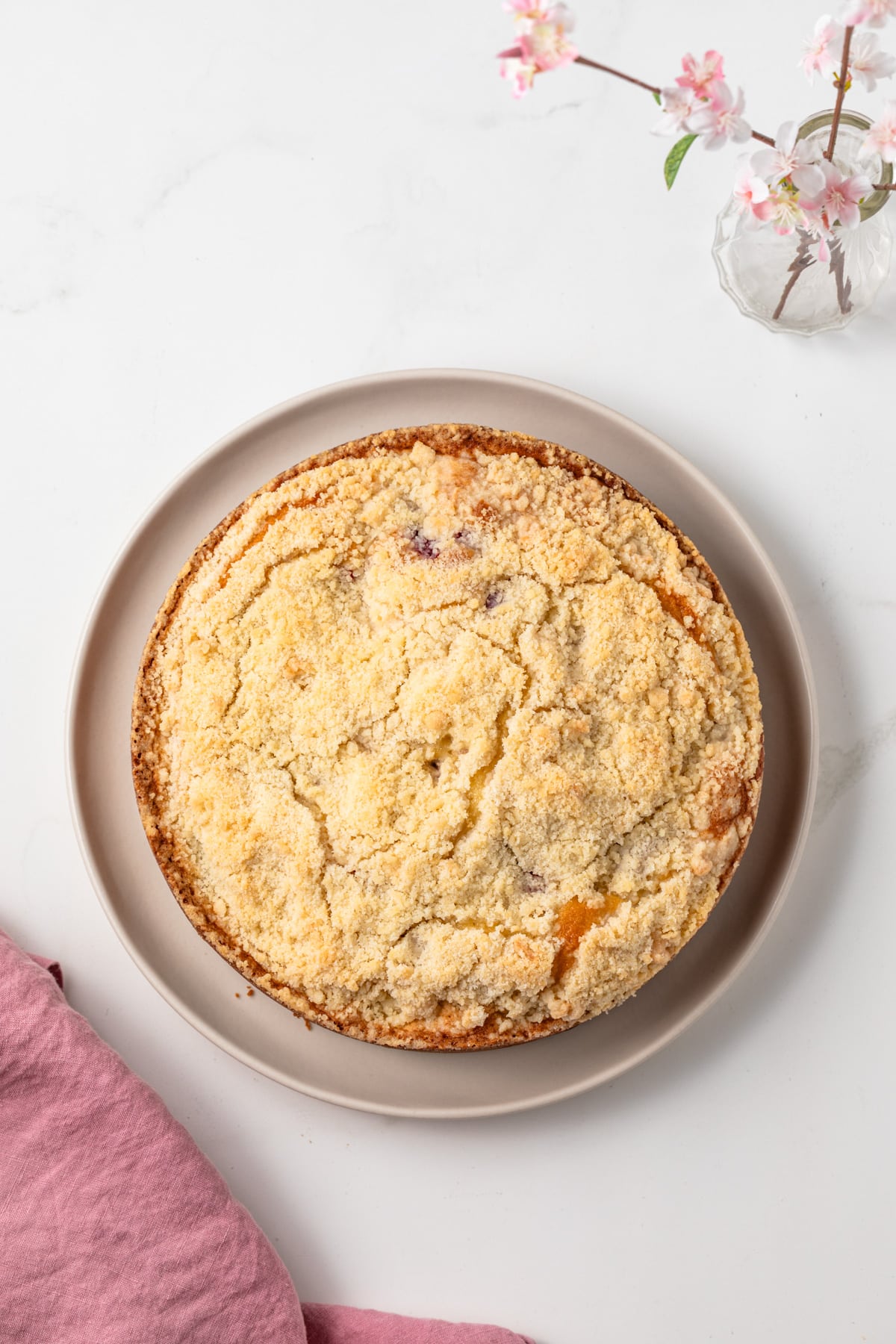 Berry crumb cake on serving platter.