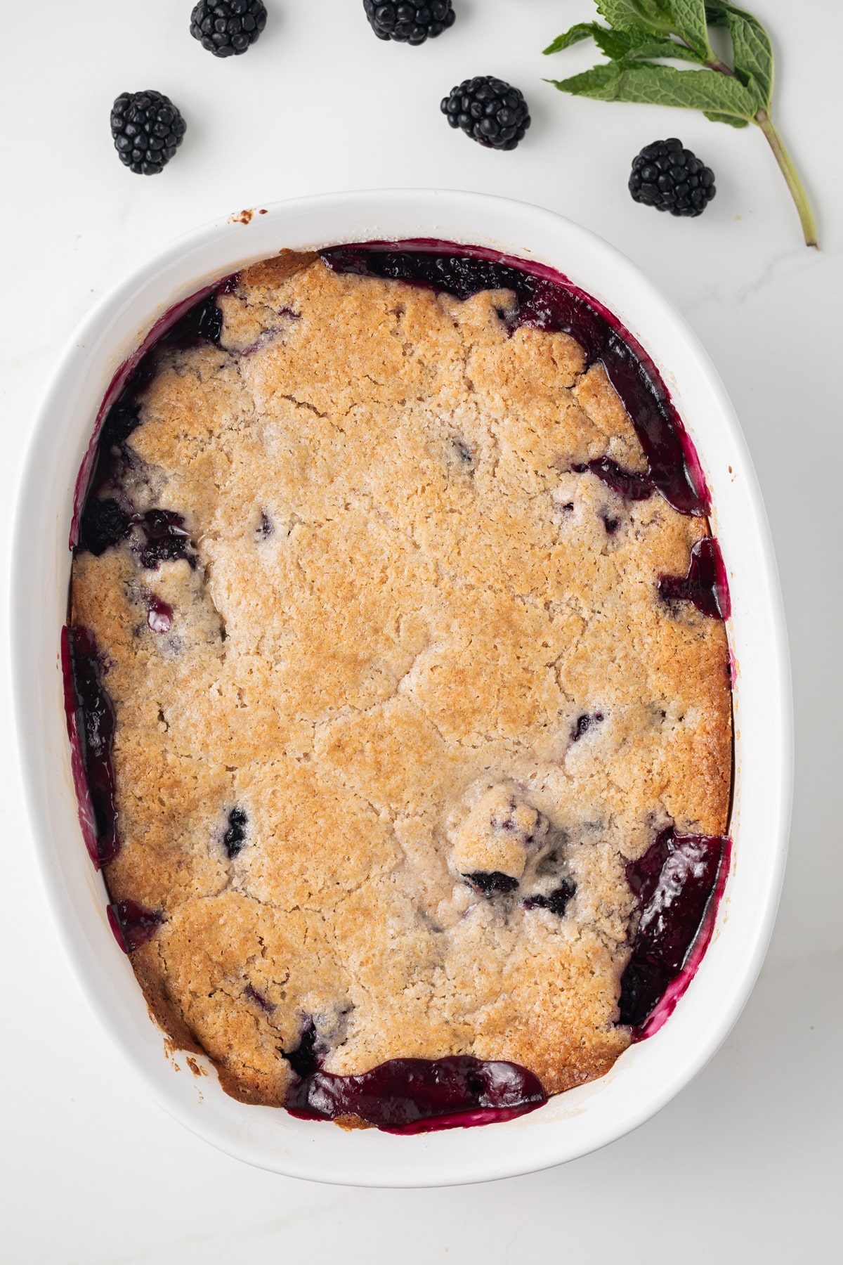 Overhead of blackberry cobbler in casserole dish.