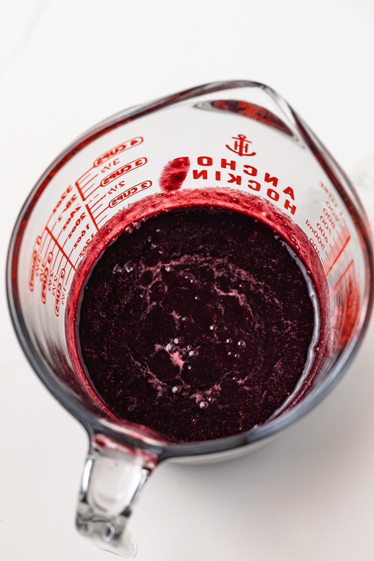 Seedless blackberry puree in glass measuring cup.