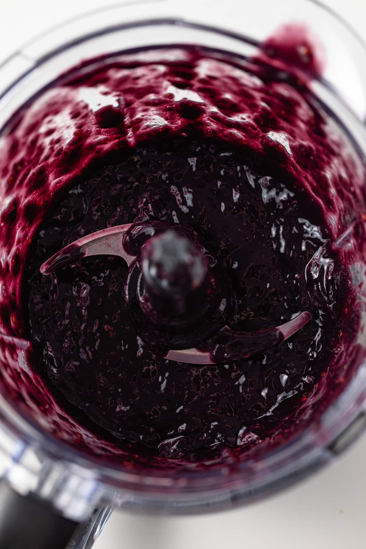 Pureed blackberries in food processor.