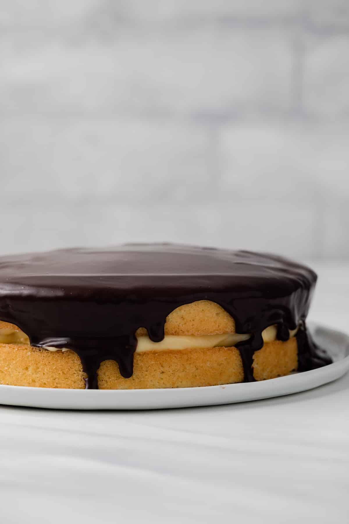 Boston cream pie on white plate.