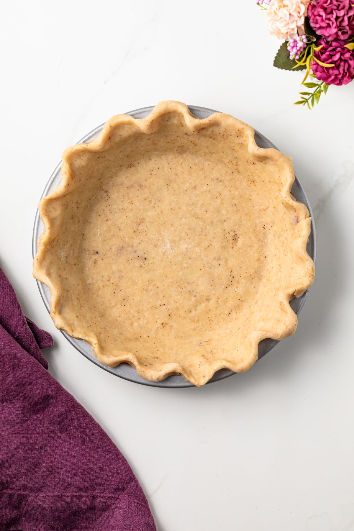Overhead of brown butter pie crust in pie plate.