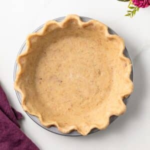 Overhead of brown butter pie crust in pie plate.