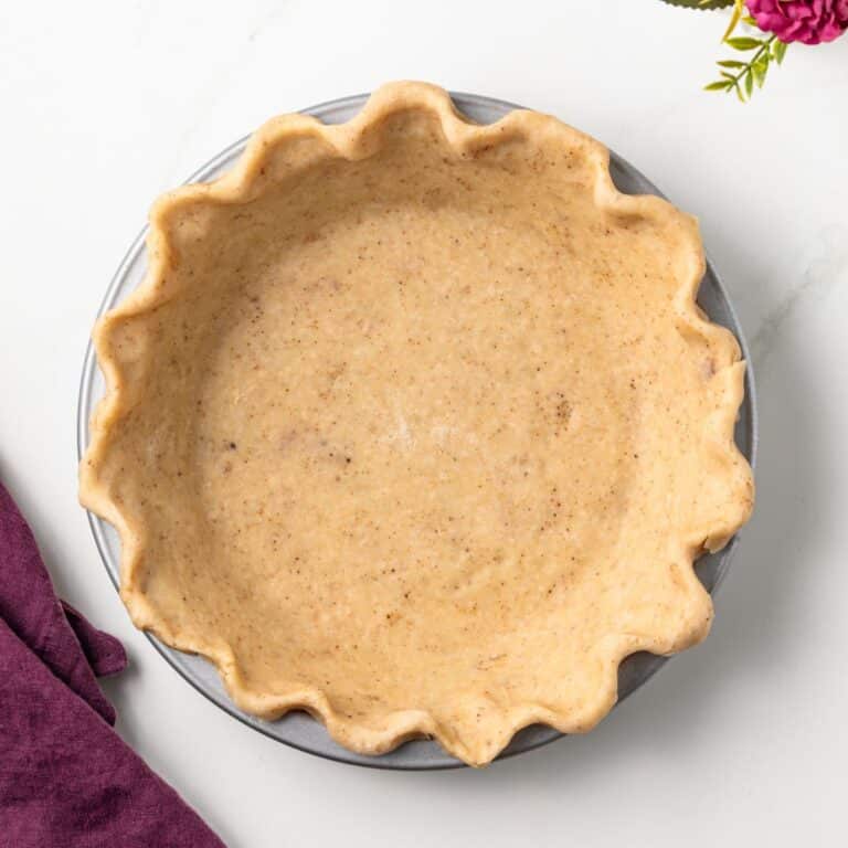 Overhead of brown butter pie crust in pie plate.