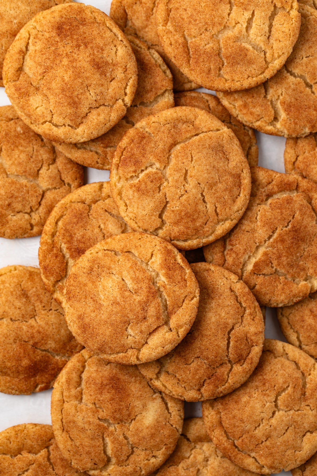 Brown butter snickerdoodles scattered on baking pan.
