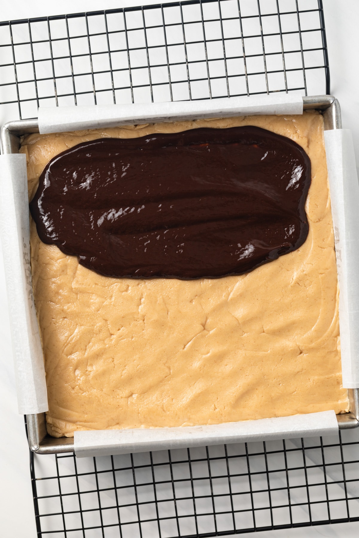Chocolate ganache over brownies with peanut butter toping.