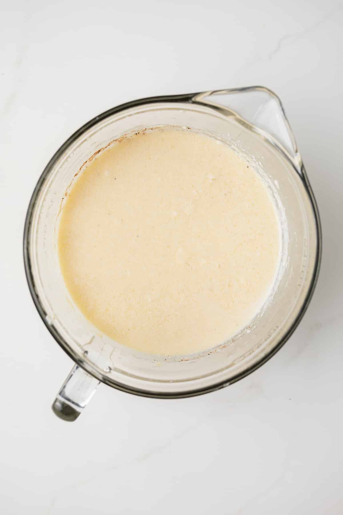 Filling for buttermilk pie in glass bowl.
