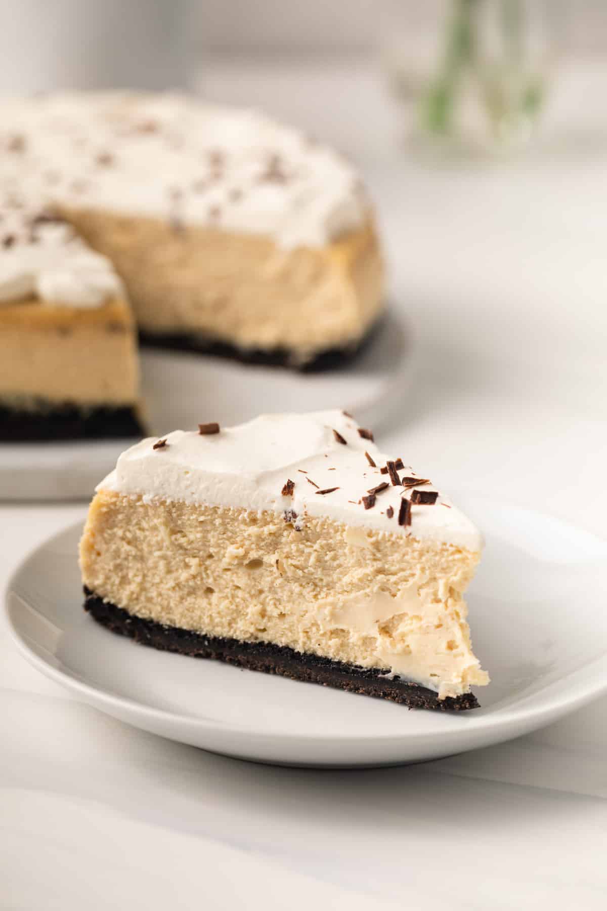 Slice of cappuccino cheesecake on a white plate.