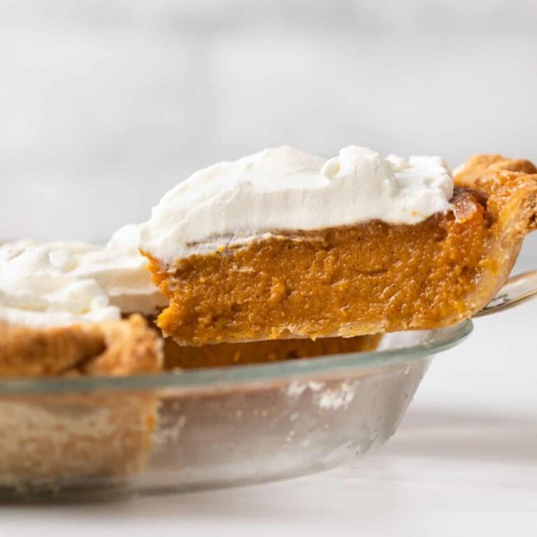 A slice on caramel sweet potato pie being served from the pan