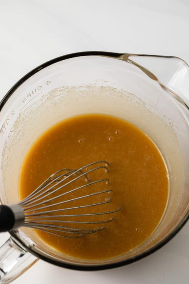 Wet ingredients mixed in a glass bowl.