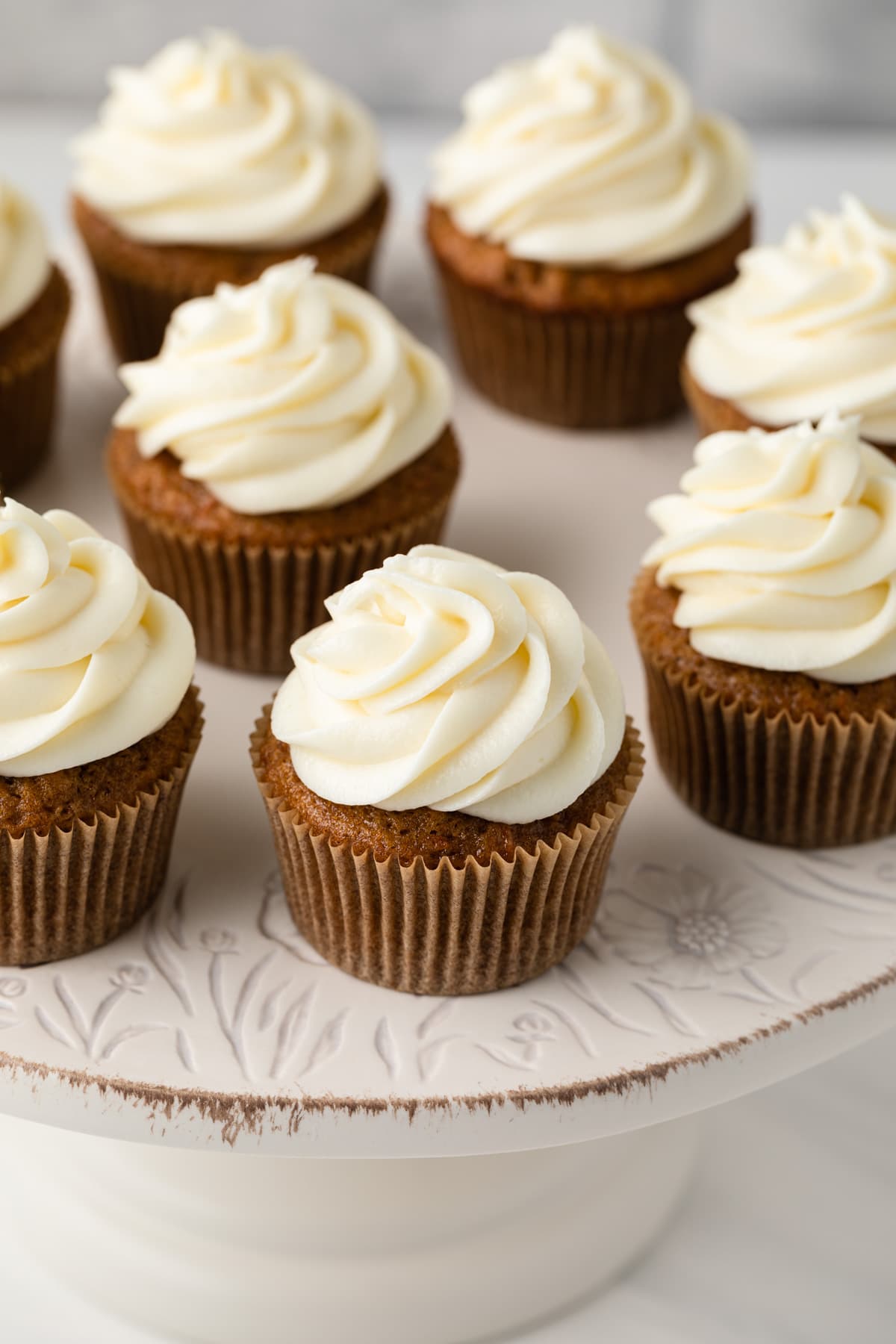 High angled view of carrot cake cupcakes on cake stand.