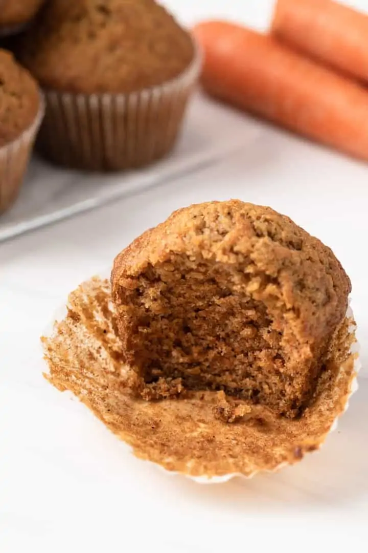A bite taken out of carrot cake muffin.