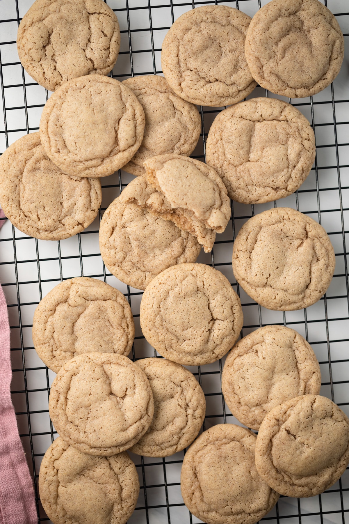 Chai cookies scattered on wire rack.