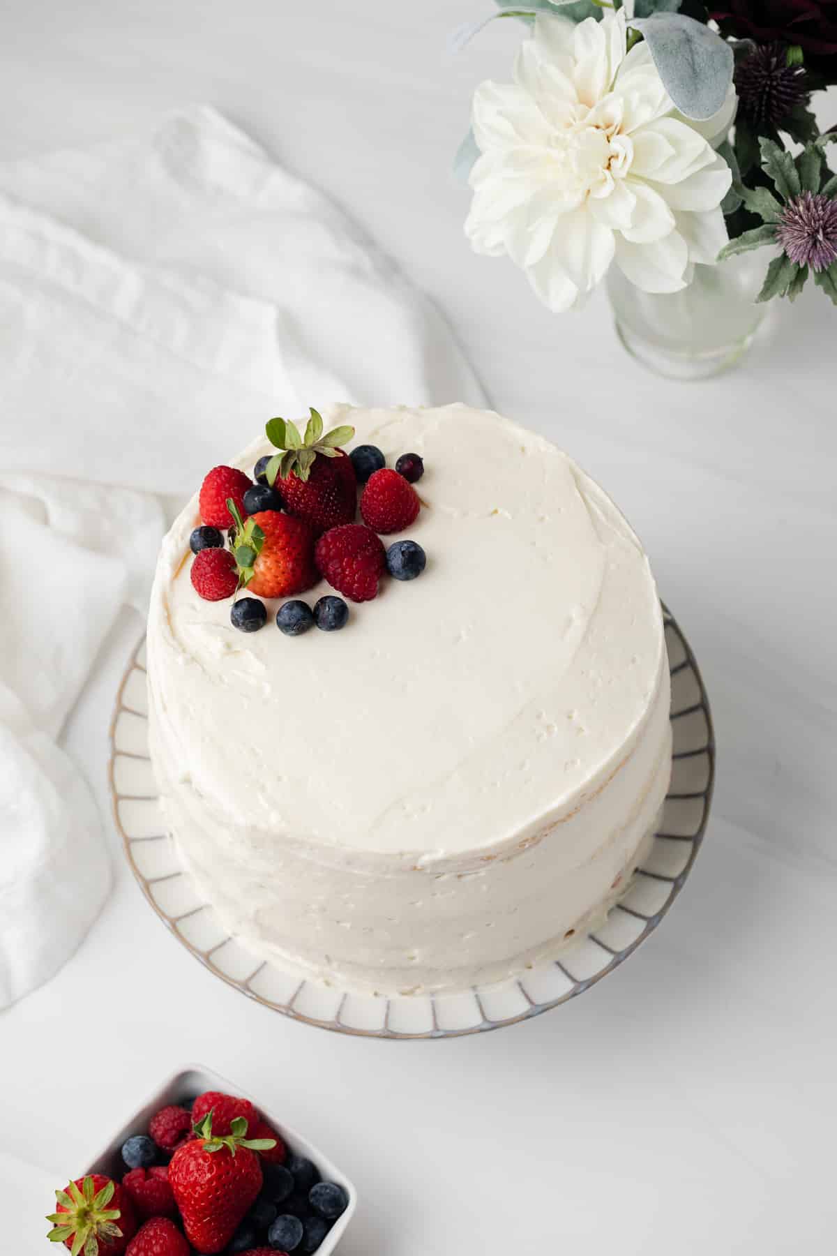 High angled view of chantilly cake on a cake stand.