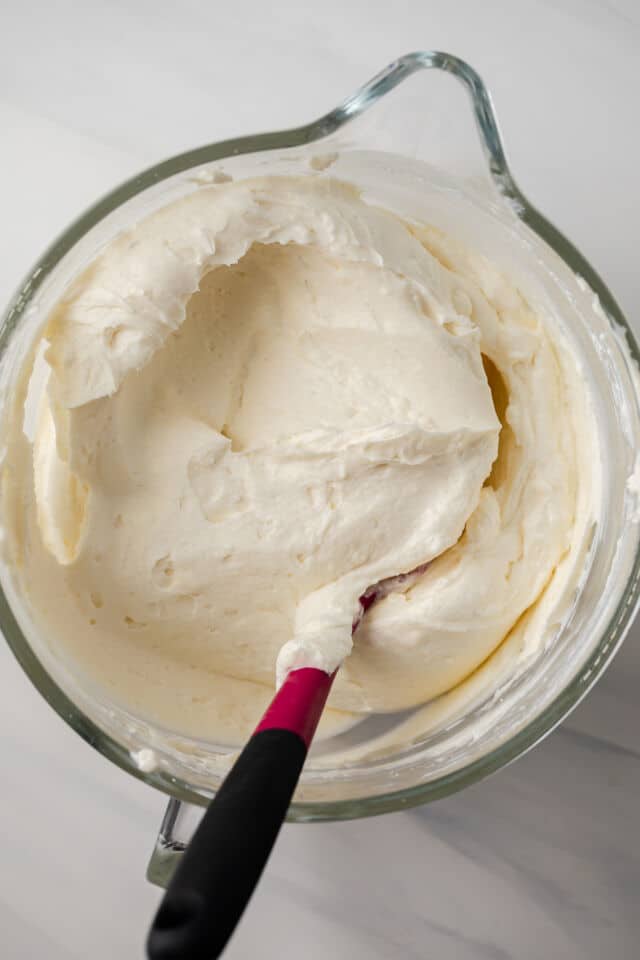 Chantilly cream in a glass mixing bowl.