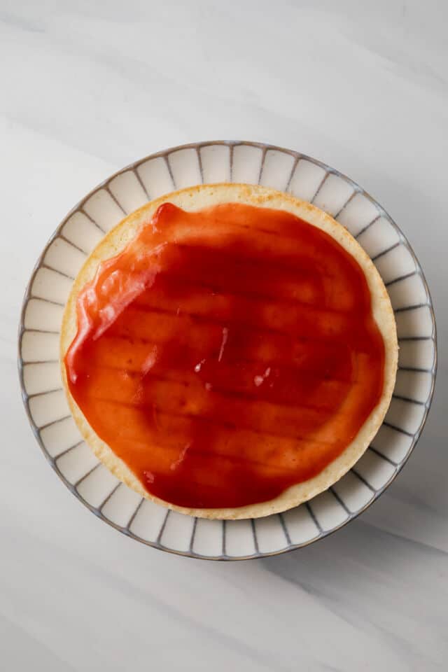 Strawberry jam layered over vanilla cake.
