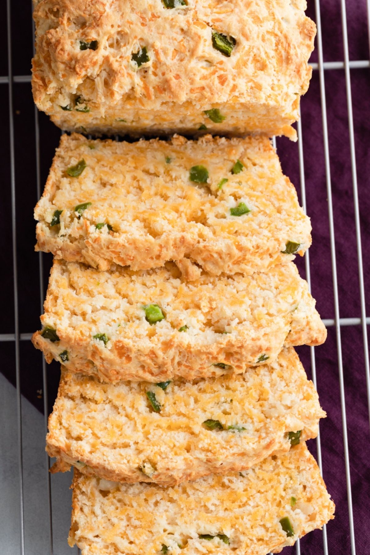 sliced cheddar jalapeno buttermilk bread on a wire rack