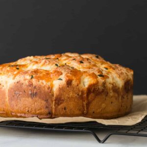 side view of Cheesy Garlic Pull Apart Rolls on a wire rack