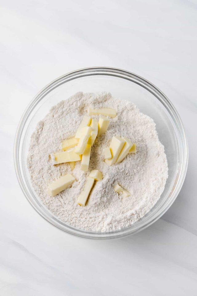 Cold butter in a bowl with dry ingredients