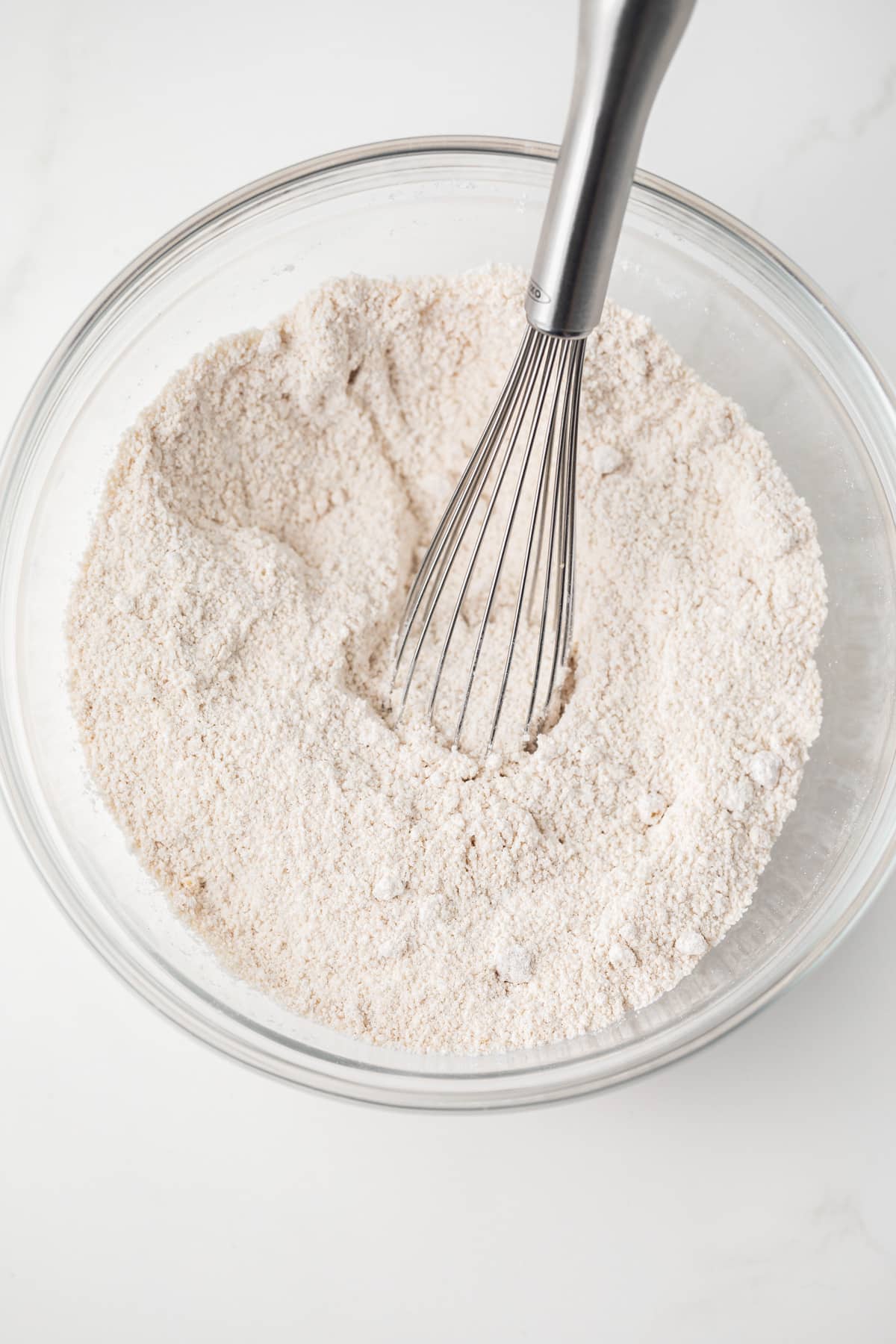 Dry ingredients mixed in glass bowl.