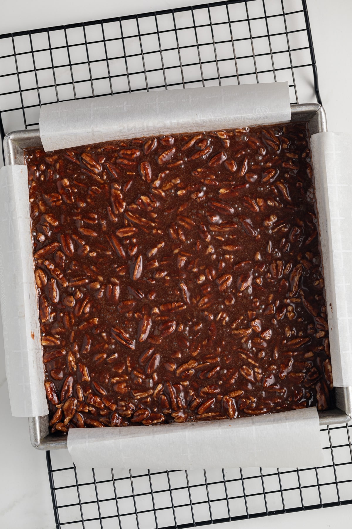 Unbaked chocolate bourbon pecan bars.
