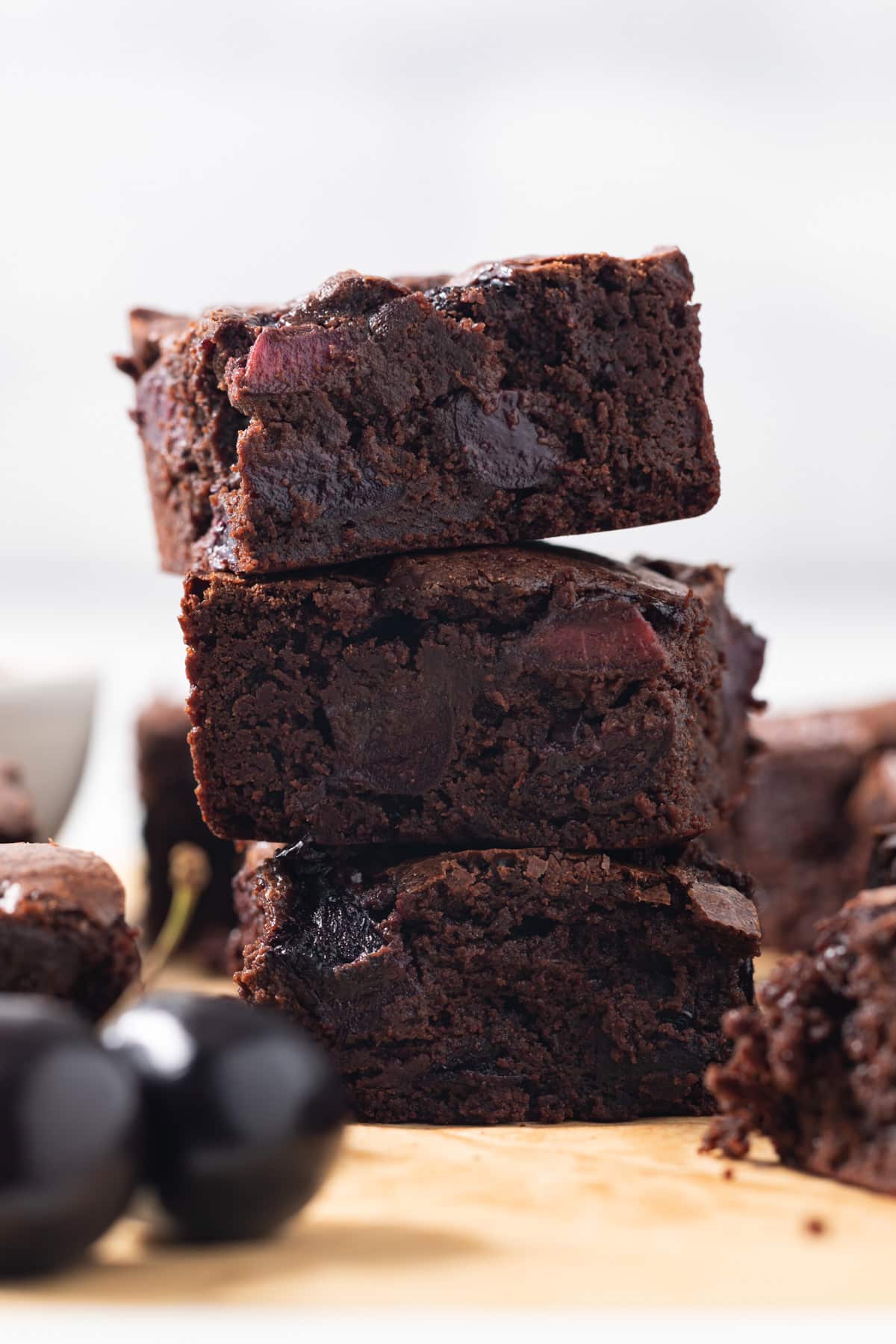 Three chocolate cherry brownies stacked.