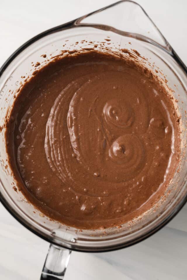 Chocolate cupcake batter in glass bowl.