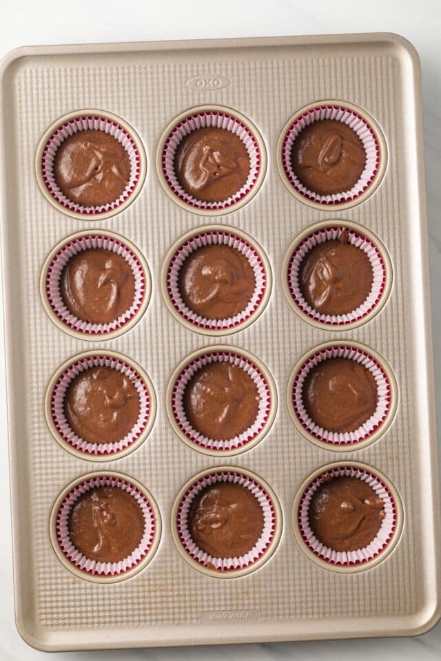 Chocolate cupcake batter in muffin pan.