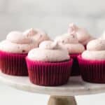 Chocolate cherry cupcakes on cake stand.